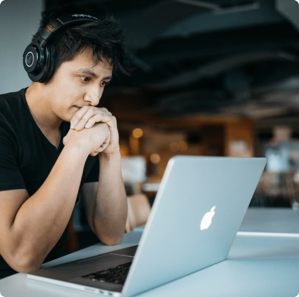 programmer with headphones on working remotely